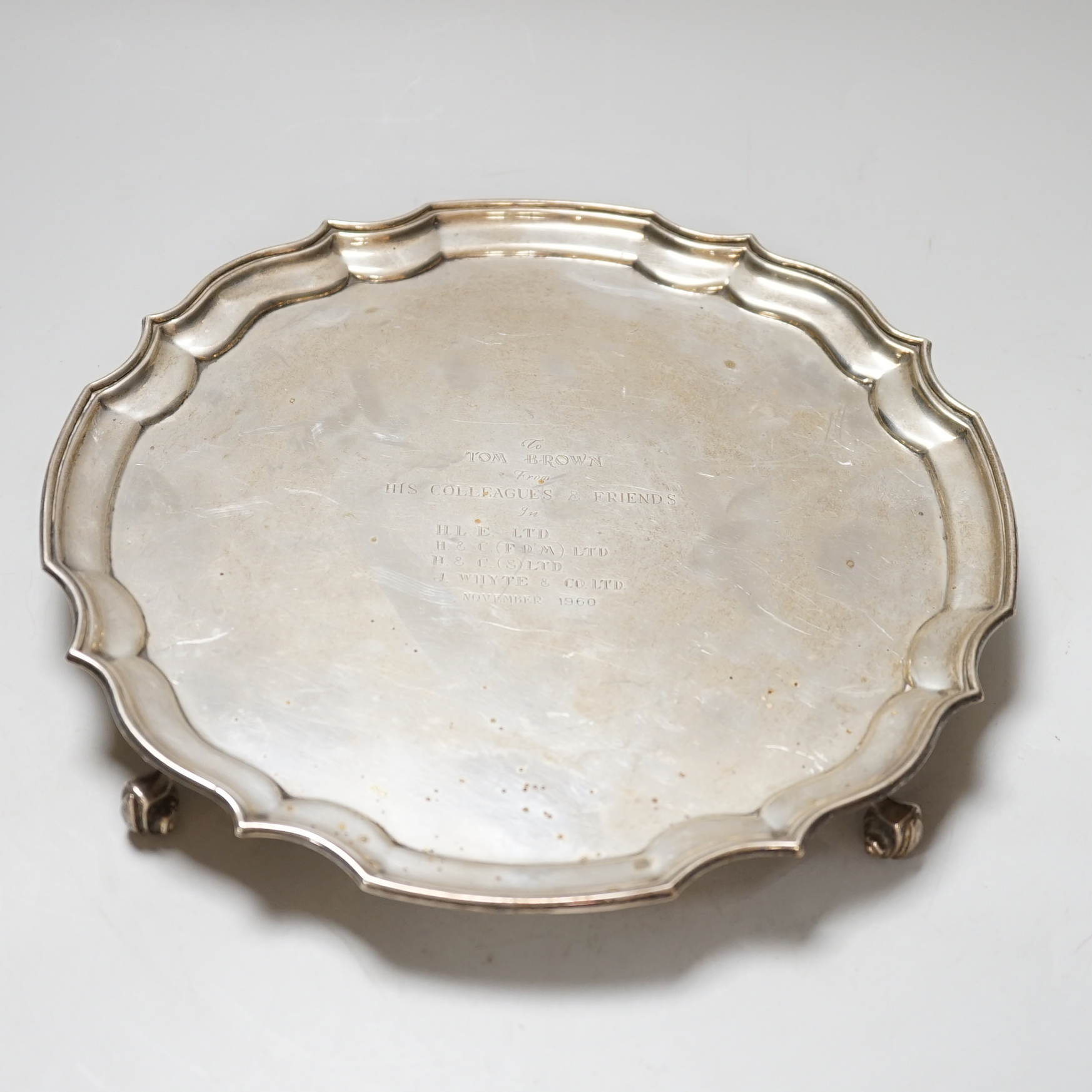 An Elizabeth II silver salver, with 1960 presentation inscription, piecrust rim and scroll feet, Birmingham 1959, 25.5cm, 516 grams
